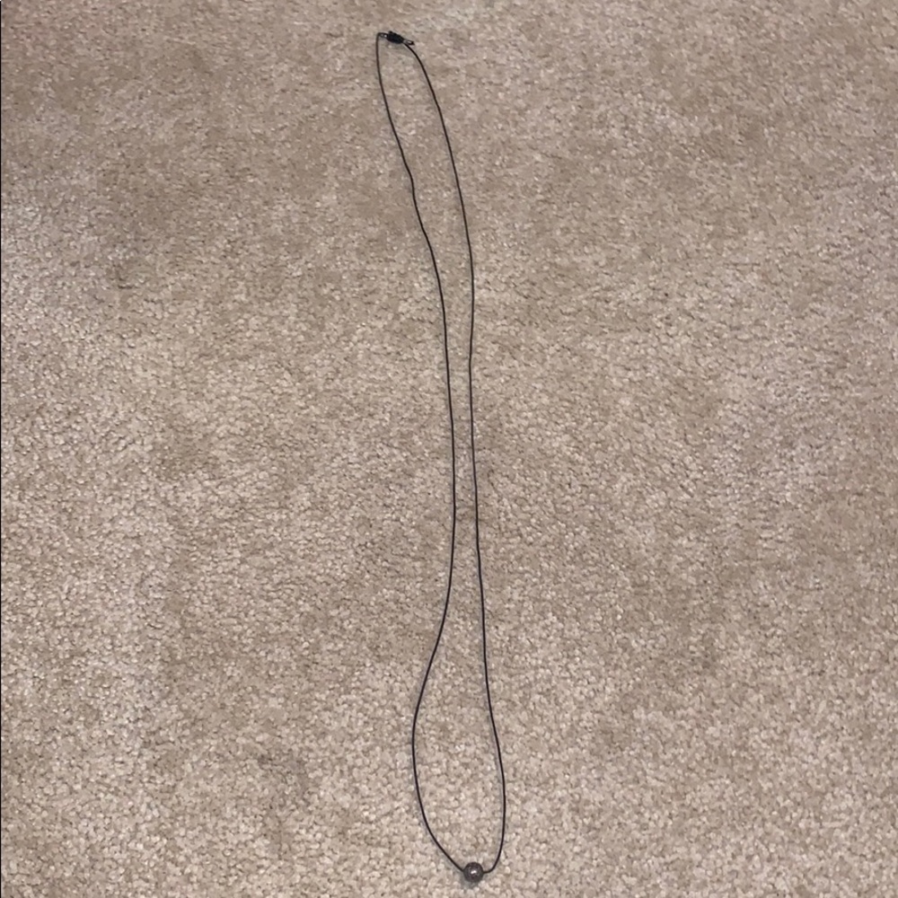 black necklace with dark silver stone